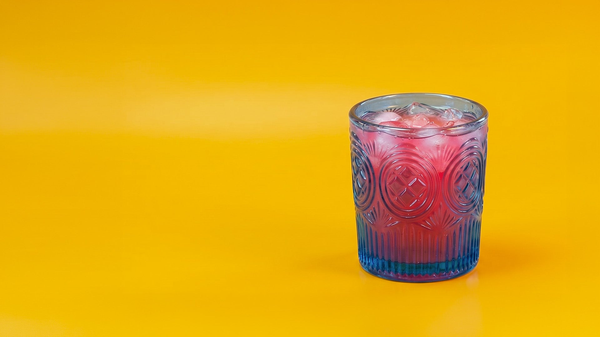Pink iced drink on a yellow background